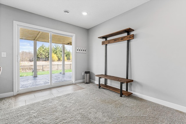 doorway featuring baseboards and recessed lighting