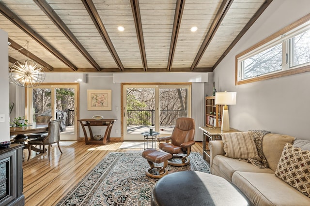 living area featuring a chandelier, wood ceiling, light wood-type flooring, and lofted ceiling with beams