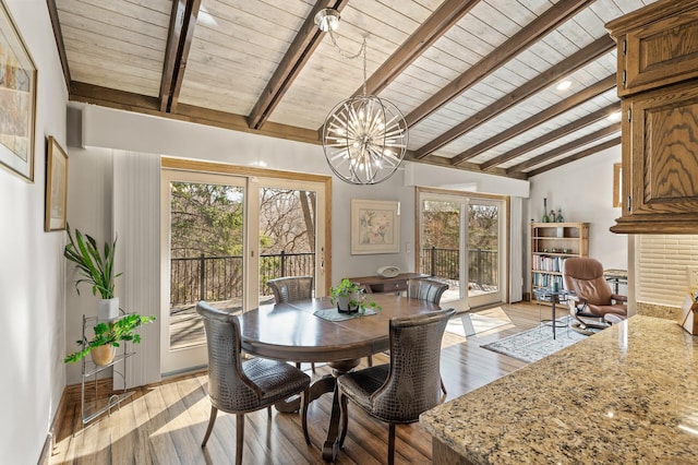 dining room with a notable chandelier, wood ceiling, light wood-type flooring, and vaulted ceiling with beams