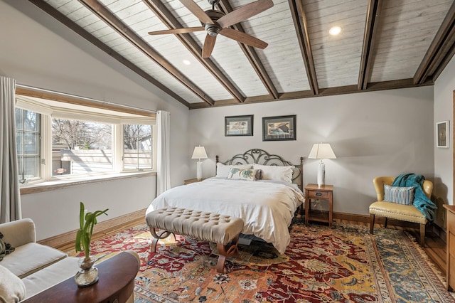 bedroom featuring lofted ceiling with beams, wood finished floors, baseboards, and wooden ceiling