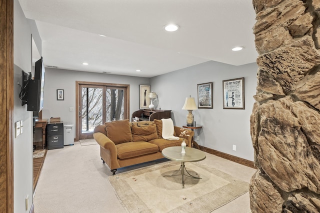 living area featuring recessed lighting, light colored carpet, and baseboards