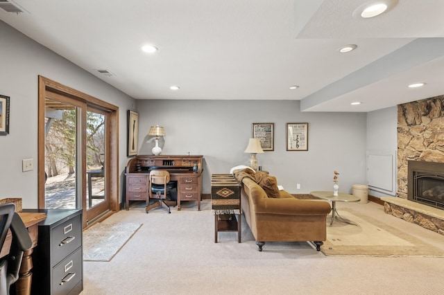 living area with recessed lighting, visible vents, light carpet, and a stone fireplace