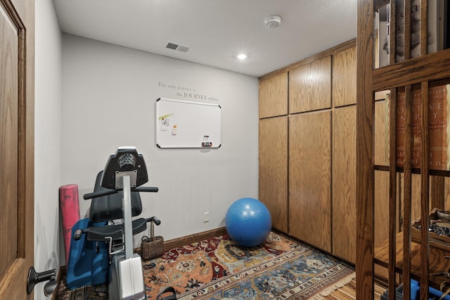 exercise room featuring visible vents and baseboards