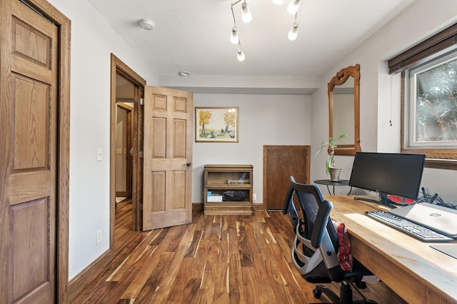 office space with wood finished floors and baseboards