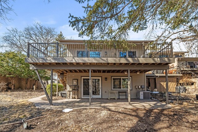 rear view of house featuring cooling unit, a patio area, a wooden deck, and stairway