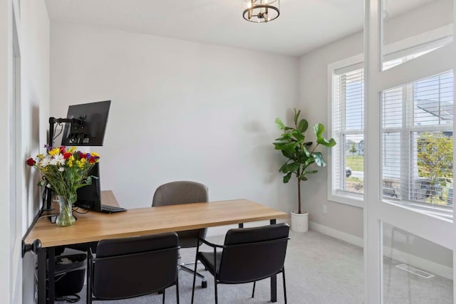 carpeted home office featuring baseboards