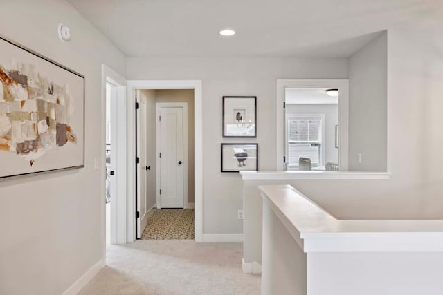 corridor with recessed lighting, baseboards, and light carpet