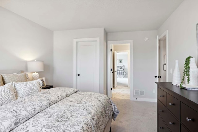 carpeted bedroom with visible vents and baseboards