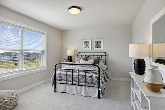 bedroom featuring visible vents, baseboards, and carpet floors