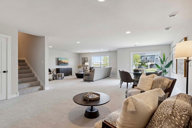 living room featuring recessed lighting, stairway, baseboards, and carpet flooring