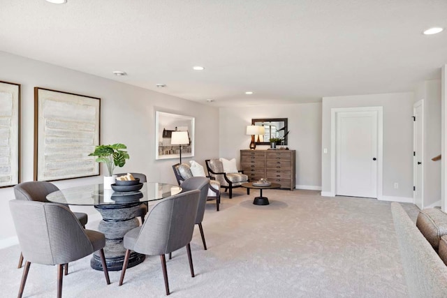 dining space featuring recessed lighting, baseboards, and light carpet