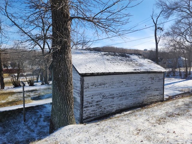 snow covered structure with an outdoor structure