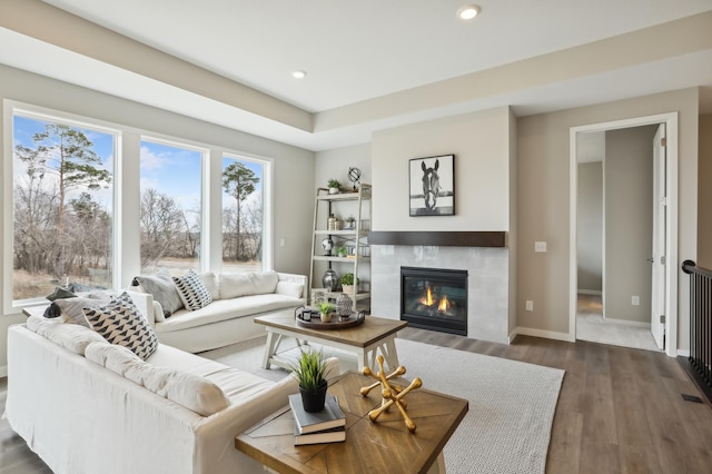 living area with recessed lighting, baseboards, a fireplace, and dark wood-style flooring