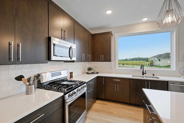 kitchen with a sink, stainless steel appliances, tasteful backsplash, and dark brown cabinets