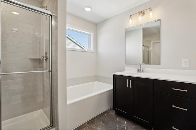 bathroom featuring a bath, a stall shower, and vanity