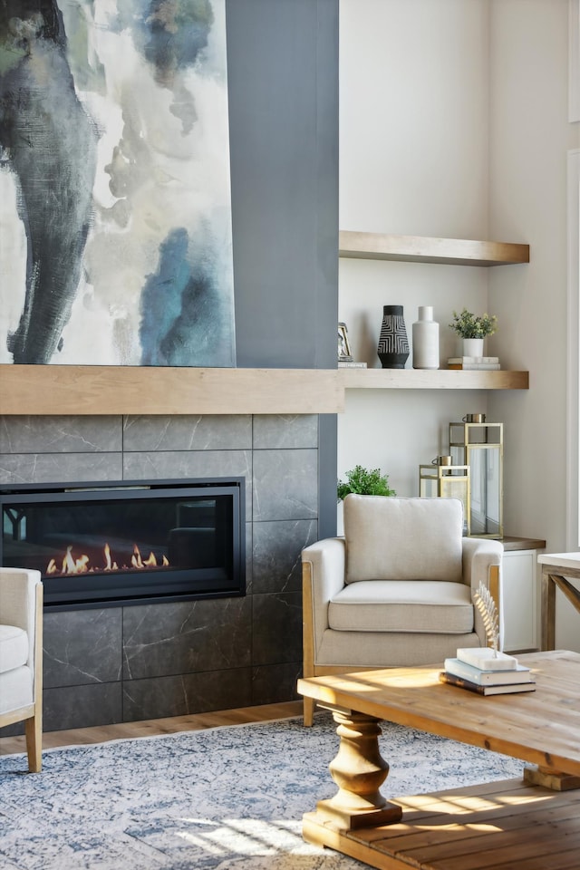 living area featuring a tiled fireplace