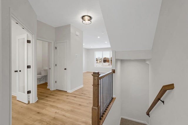 hallway featuring an upstairs landing, recessed lighting, light wood-type flooring, and baseboards