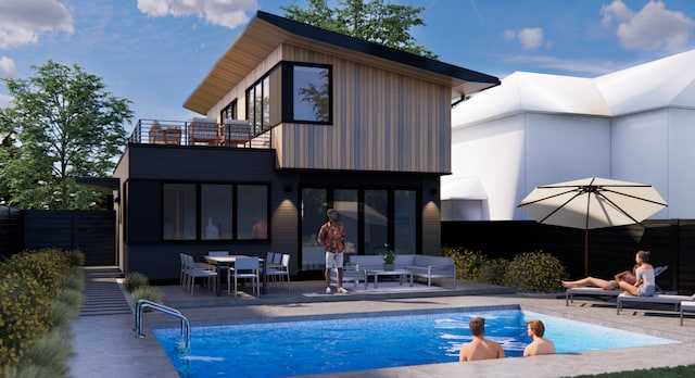 rear view of house featuring a patio, a balcony, a fenced in pool, fence, and outdoor lounge area