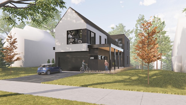 view of front facade featuring a garage, a front lawn, and driveway