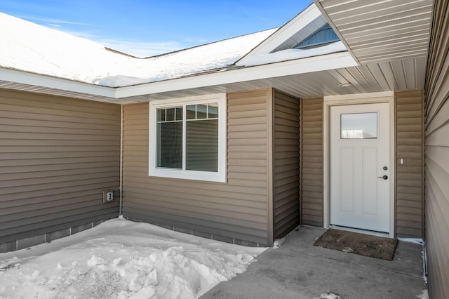 view of snow covered property entrance