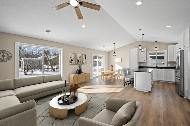 living room featuring recessed lighting, ceiling fan, lofted ceiling, and wood finished floors