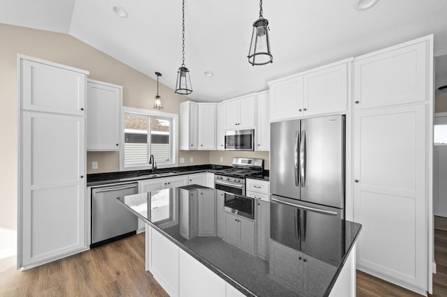 kitchen with lofted ceiling, appliances with stainless steel finishes, dark wood-style floors, white cabinetry, and a sink