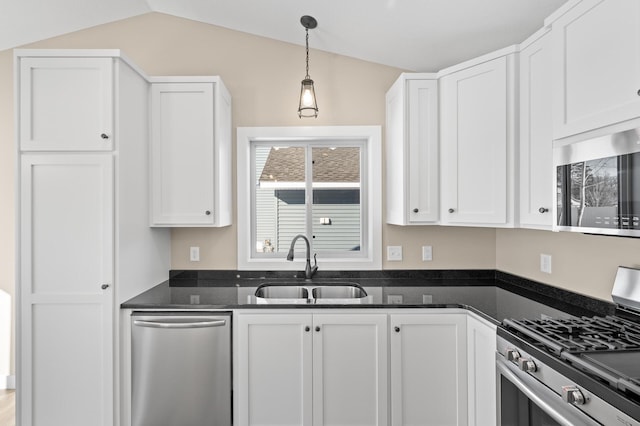 kitchen featuring a sink, white cabinets, decorative light fixtures, and stainless steel appliances