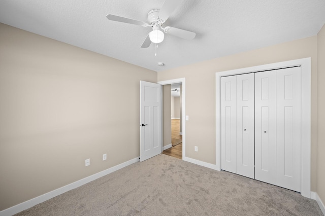 unfurnished bedroom with carpet, baseboards, and a closet