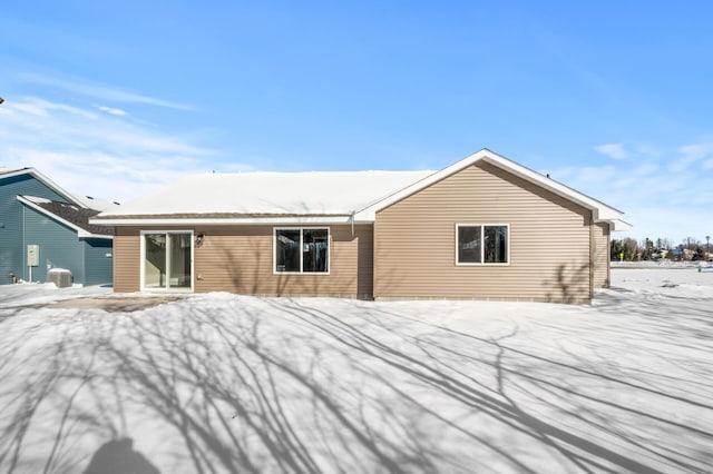 view of snow covered back of property