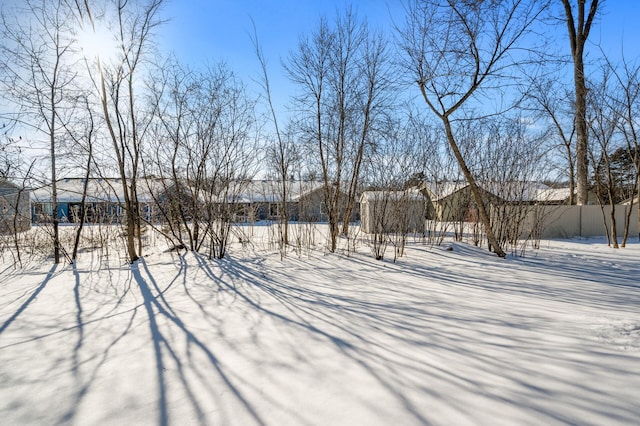 yard layered in snow with fence