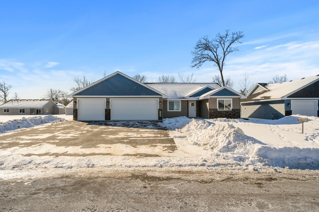 view of front facade featuring stone siding, an attached garage, and driveway