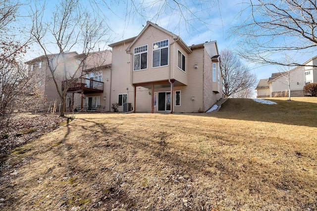 back of property featuring central AC and a yard