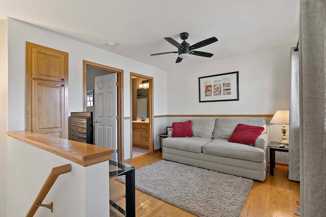 living area featuring ceiling fan and light wood-style flooring