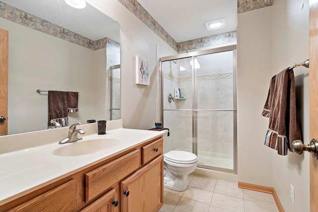 bathroom featuring toilet, a stall shower, vanity, and tile patterned flooring