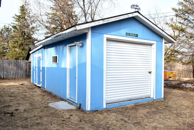 view of outdoor structure with an outbuilding and fence