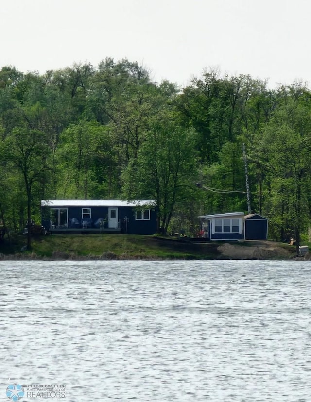 property view of water with a forest view