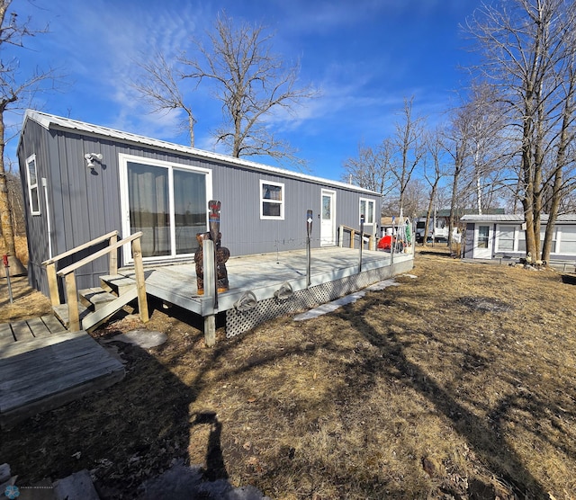 rear view of property featuring a deck