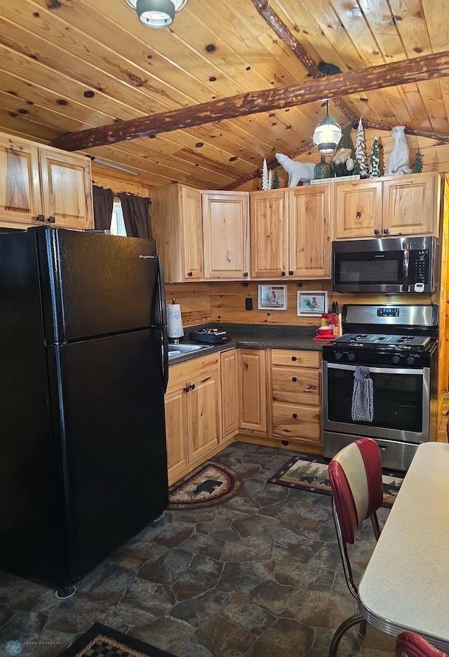 kitchen with dark countertops, wood ceiling, lofted ceiling, freestanding refrigerator, and gas stove