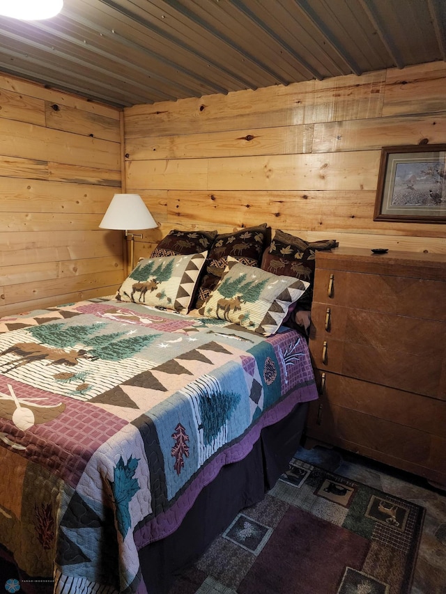 bedroom featuring wooden walls and wood ceiling