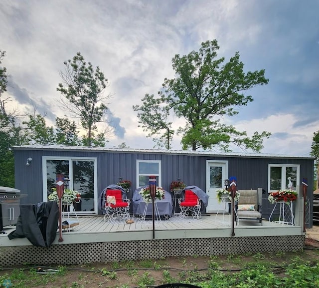 rear view of property with a wooden deck