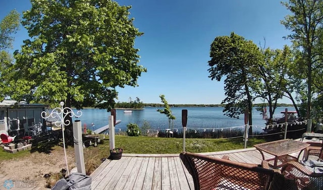 exterior space featuring a lawn and a water view