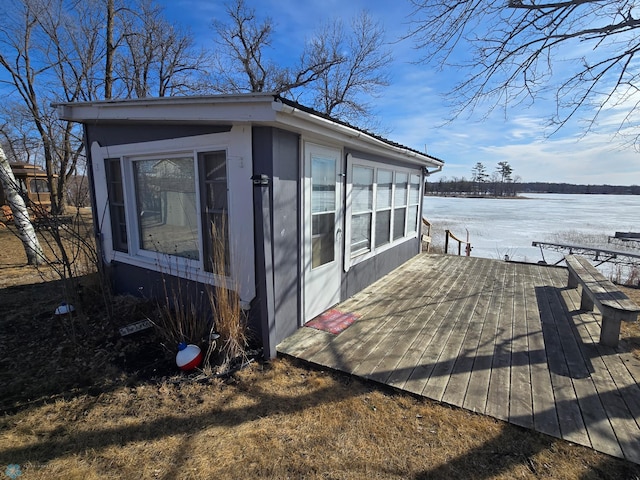 exterior space featuring an outbuilding and a deck with water view