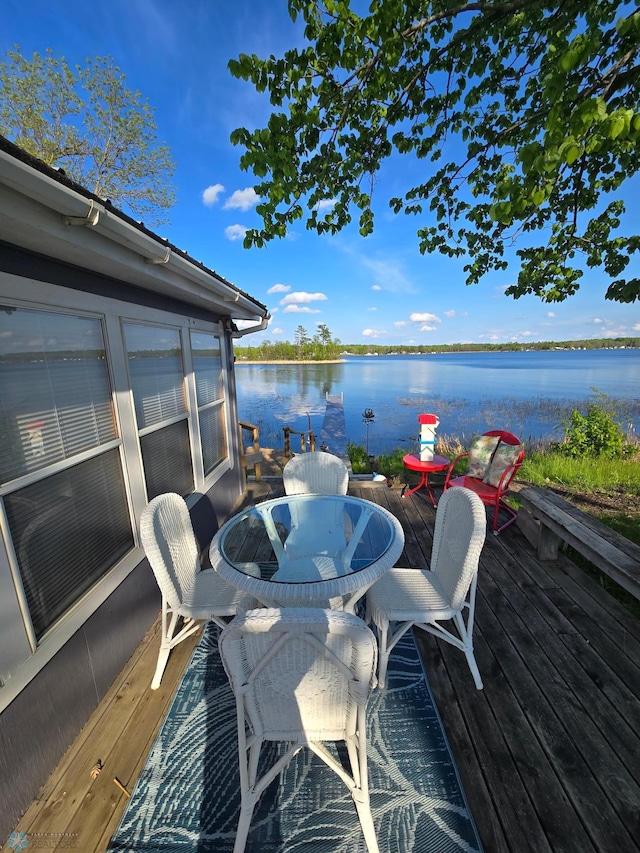 deck featuring a water view and outdoor dining space