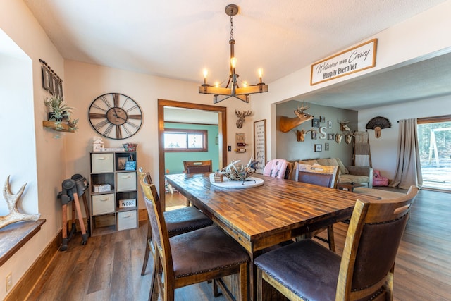 dining room with baseboards, an inviting chandelier, and dark wood-style flooring