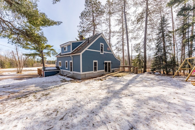 view of property exterior featuring a deck and a chimney