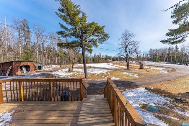 snow covered deck with an outdoor structure