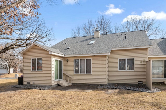 back of property with entry steps, roof with shingles, and a chimney