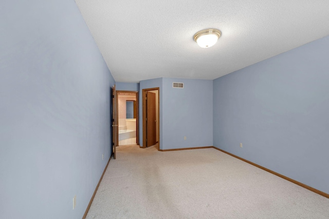 unfurnished bedroom with light colored carpet, baseboards, visible vents, and a textured ceiling