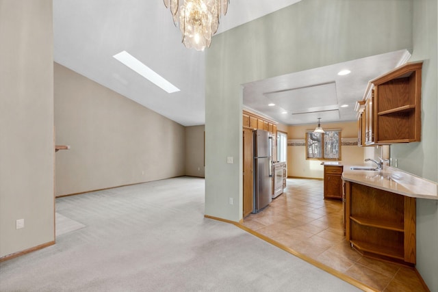 kitchen with open shelves, light countertops, freestanding refrigerator, and light carpet