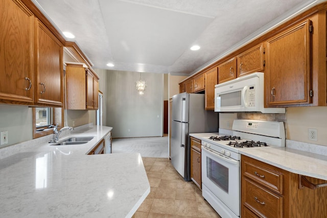 kitchen with brown cabinets, white appliances, and a sink